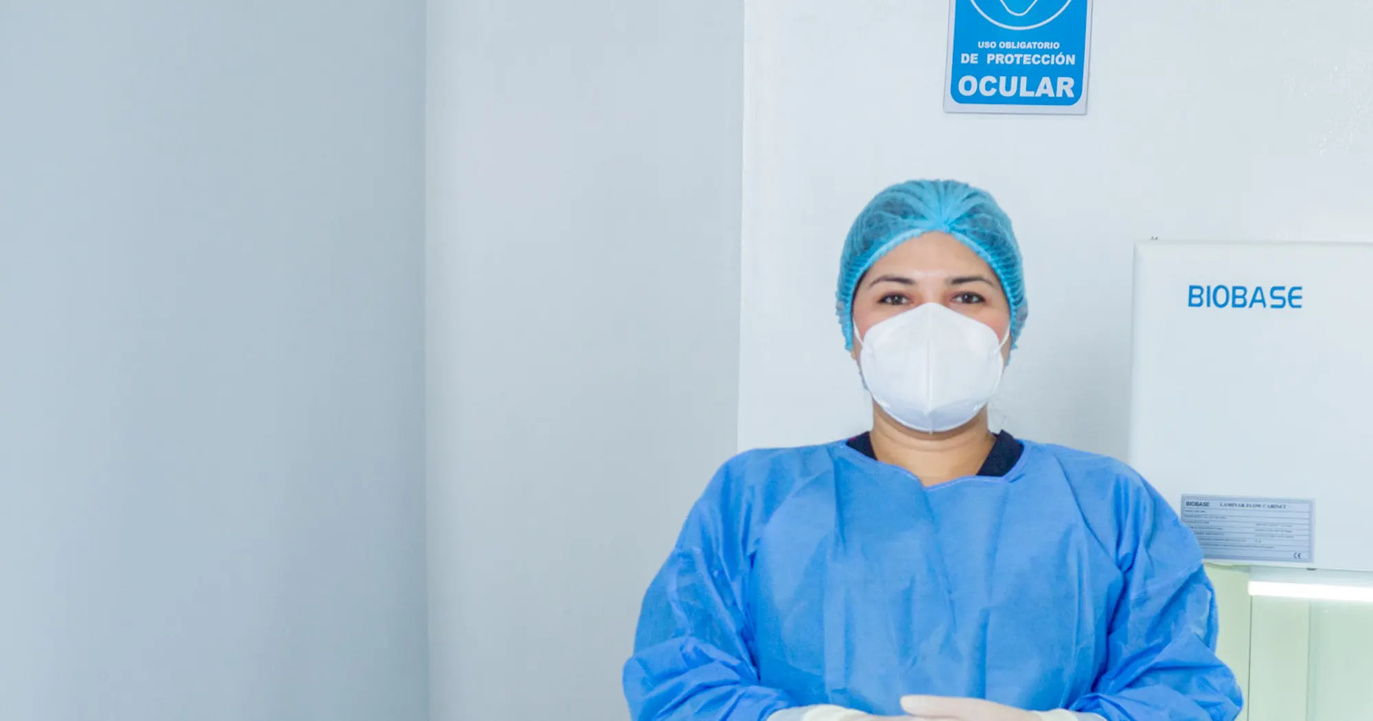 Personal de OncoCare con equipo de protección junto a la cabina de preparación
